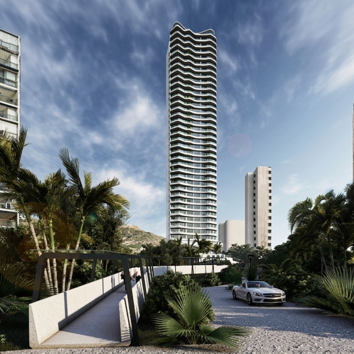 View of the Skyhotel entrance, with the tower in the background and palm gardens