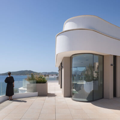 Penthouse terrace of the ONE Ibiza with curved glazing and sea views.