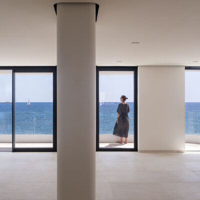 Interior space of the ONE Ibiza connected to a sea-facing terrace.